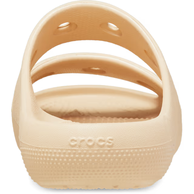 Beige sandal with 'Crocs' branding on a white background