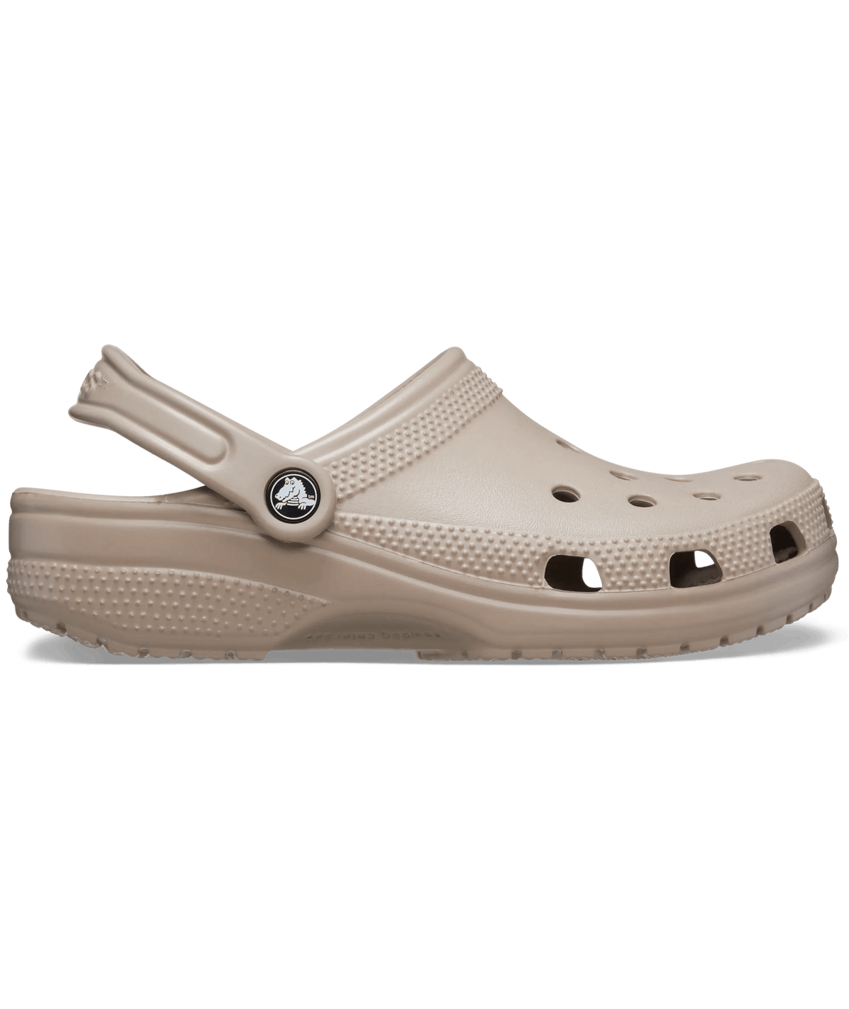 A single Croc-style clog in a light taupe-beige color, shown from a side profile view against a plain white background.
