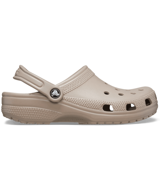 A single Croc-style clog in a light taupe-beige color, shown from a side profile view against a plain white background.