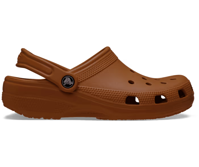 A brown Crocs Classic Clog with a closed toe and multiple holes on the upper part.