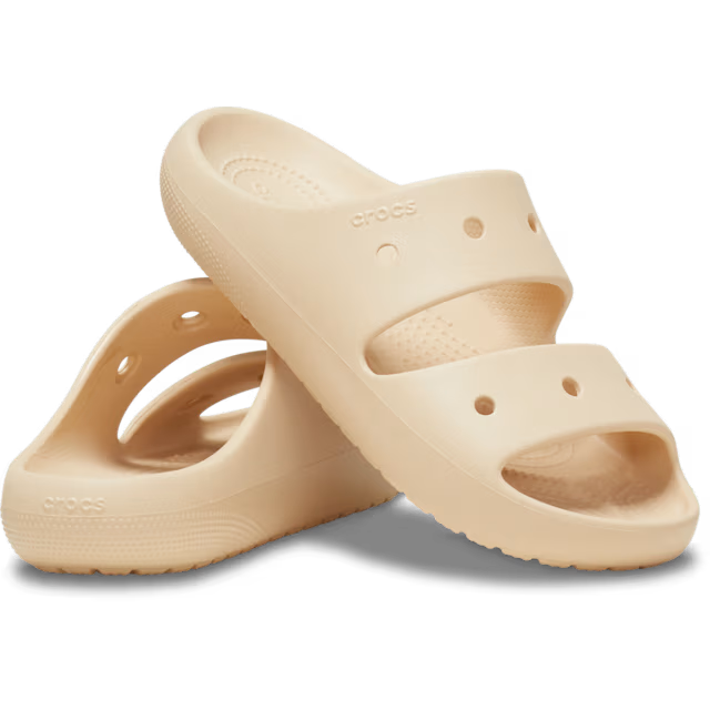 Beige sandals with 'Crocs' branding on a white background