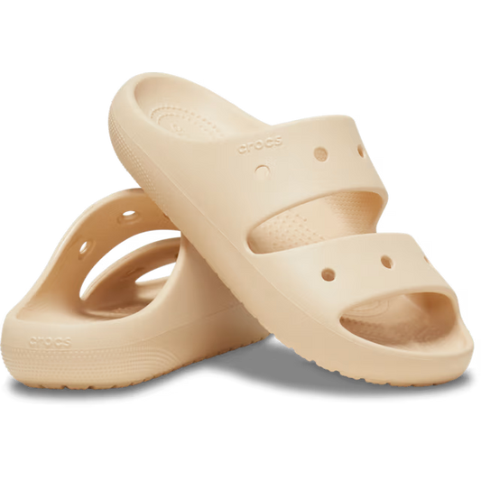 Beige sandals with 'Crocs' branding on a white background
