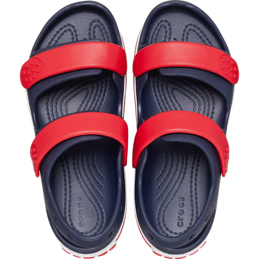 Navy and red Crocs sandals on a white background