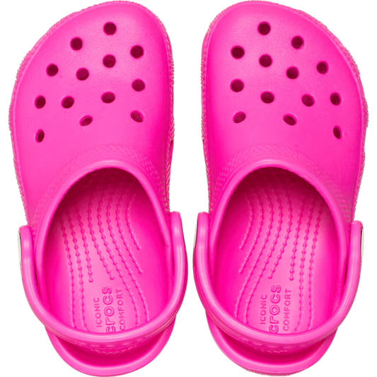 Pair of bright pink clogs on a white background