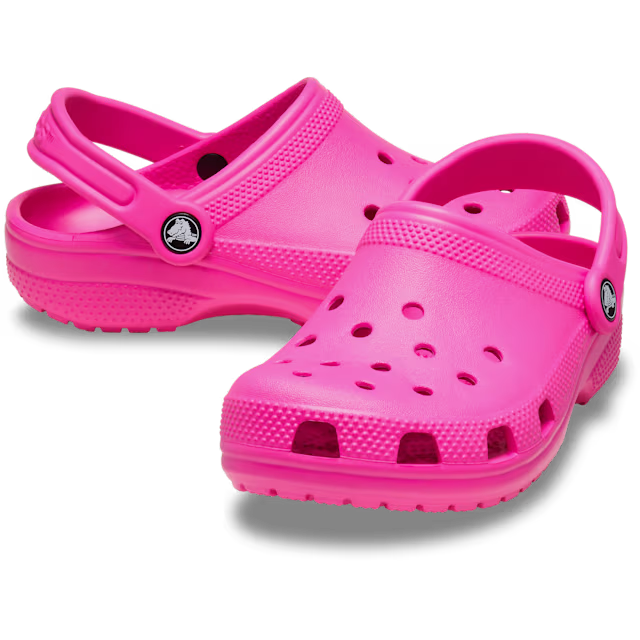Pair of bright pink clogs on a white background