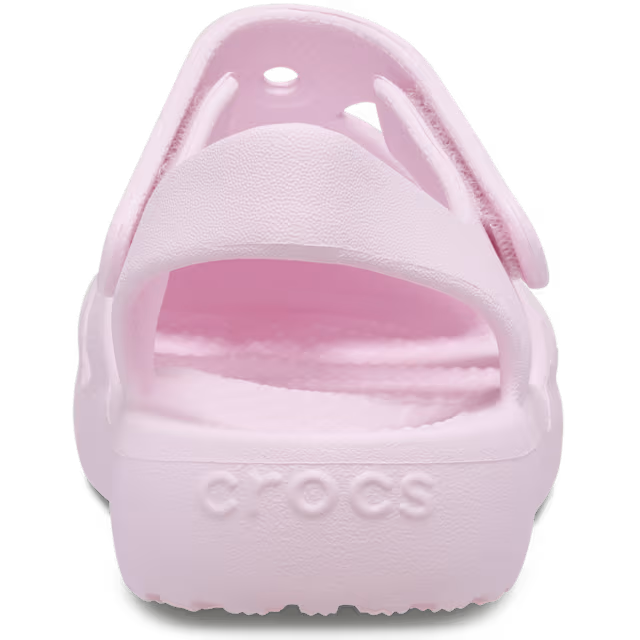 Pink sandal with 'Crocs' branding on a white background