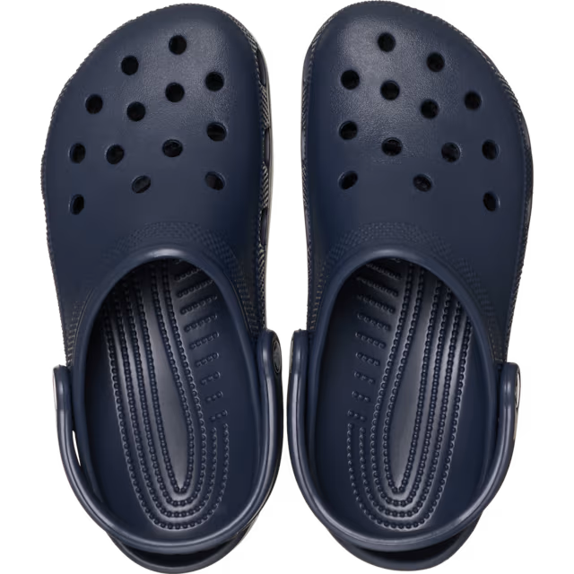 Navy blue clogs with a clear background