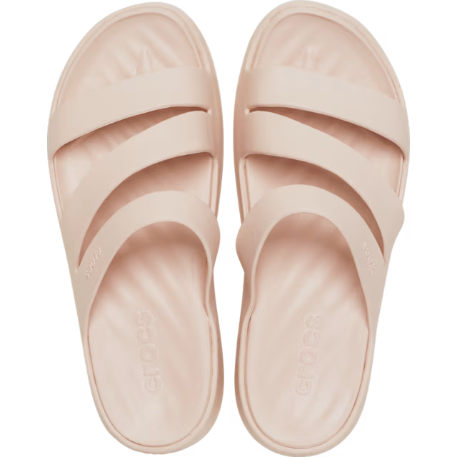 Pair of light pink sandals on a white background