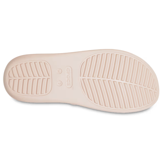 Top view of a beige shoe sole with tread pattern on a white background