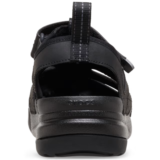 Black sandal with a strap on a white background