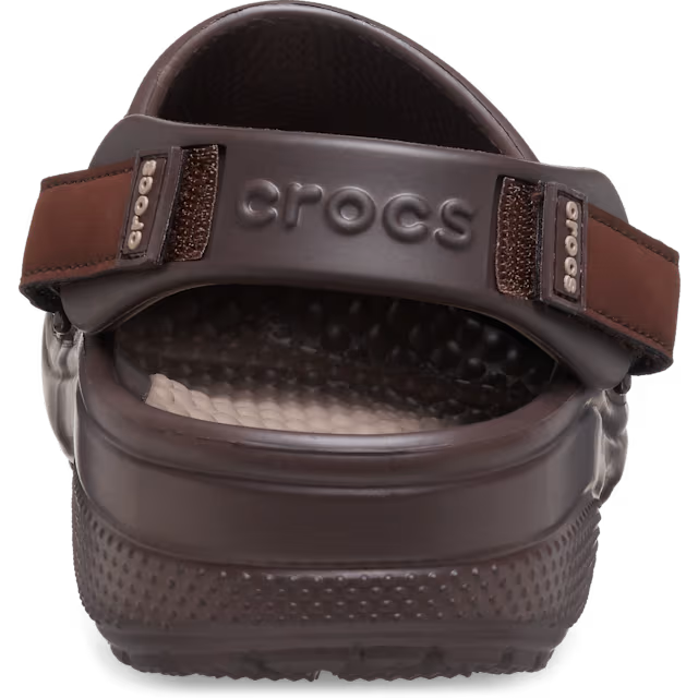 Brown Crocs sandal with a strap on a white background