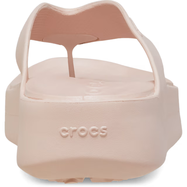 Beige sandal with 'CROCS' branding on a transparent background